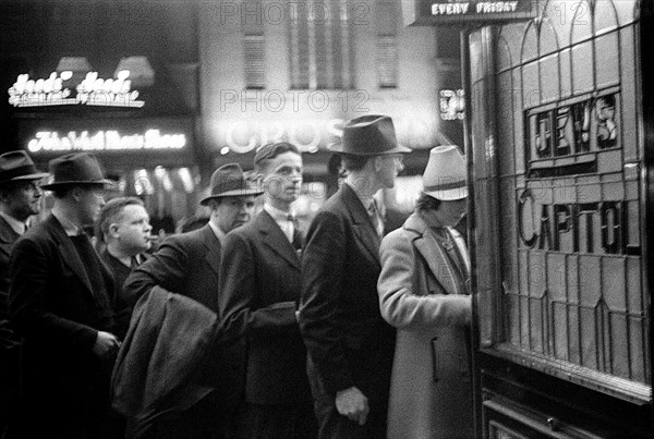 Street scene with people waiting in line