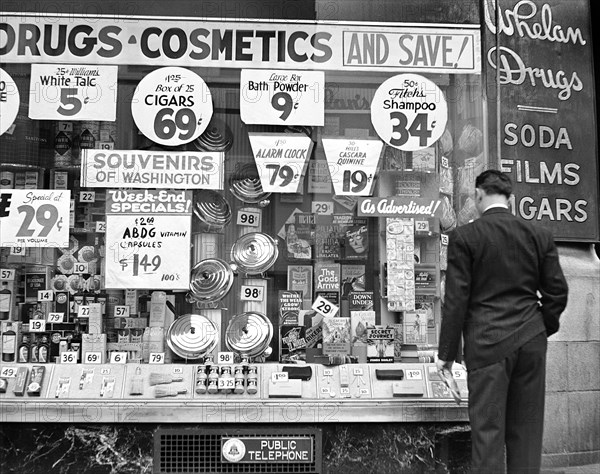 Man looking at drug store window