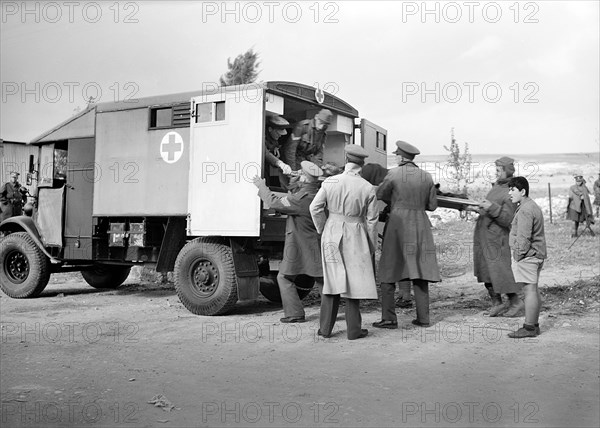 Italian prisoner of war on stretcher being  lifted into ambulance after detraining at Wadi al-Sarar Railway Station