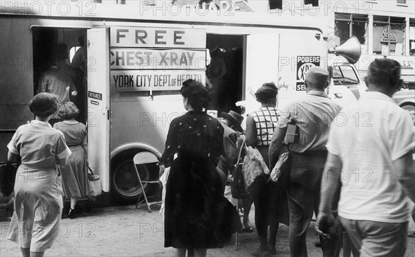 Group of men and women in line to enter free chest x-ray van operated by the New York City Department of Health