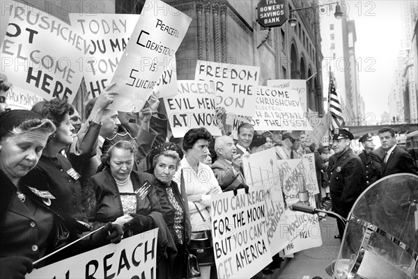 Protesters holding signs with slogans including "Khrushchev not welcome here" and "Peaceful coexistence is suicide" during Nikita Khrushchev's U.S. visit