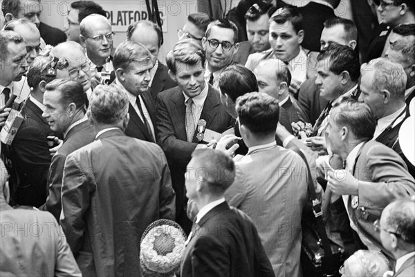 Robert F. Kennedy talking to delegates on convention floor during Democratic National Convention