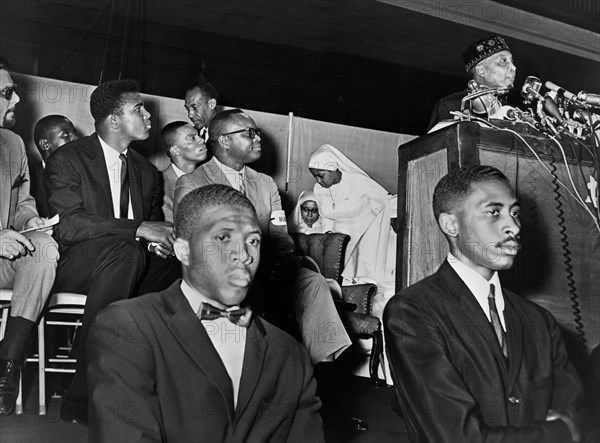 Elijah Muhammad addressing followers including Cassius Clay