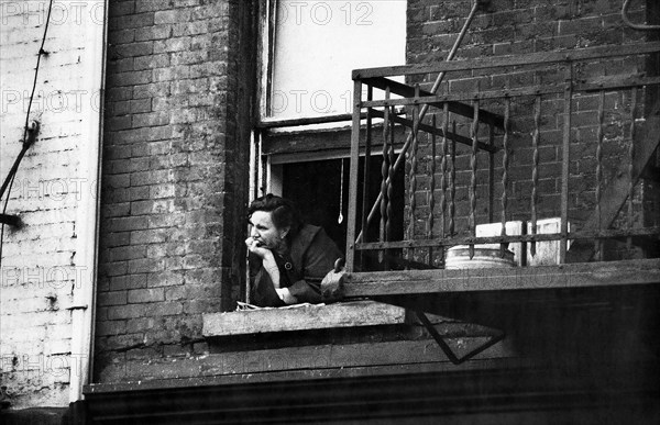 Woman leaning out building window