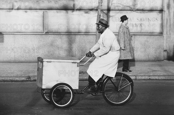 Man riding a food cart tricyle