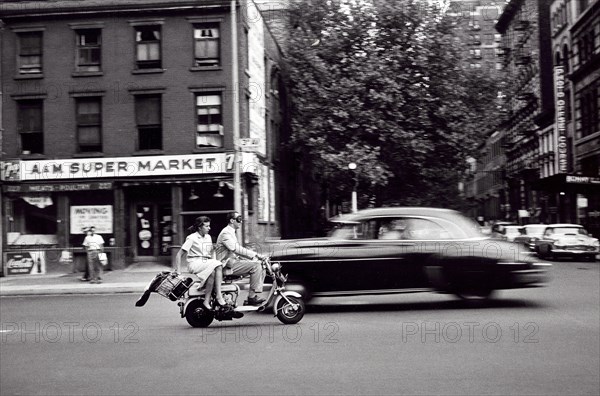 Man and woman on motorized scooter