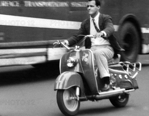 Man riding motorized scooter