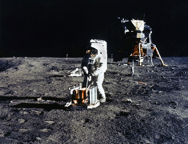 American Astronaut Edwin E. Aldrin deploying passive seismic experiments package (PSEP) during Apollo 11 extravehicular activity