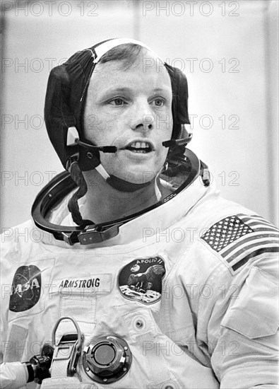 Mission commander Neil A. Armstrong conducting final check of his communications system before boarding of the Apollo 11 mission