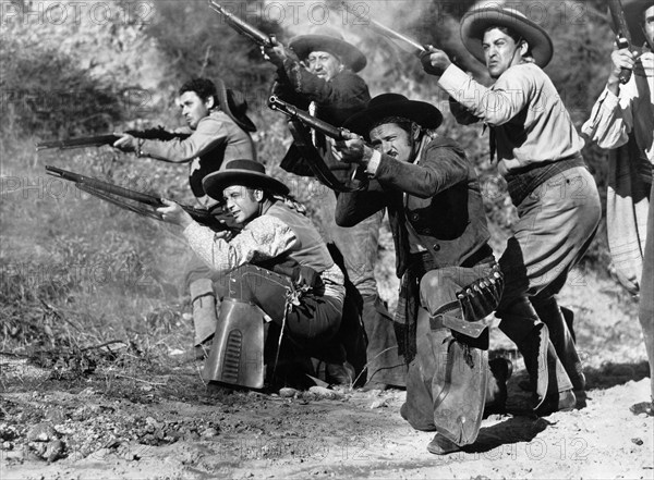 Alfonso Bedoya (standing left), Joe Dominguez (standing center), Frank Cody (kneeling left), Gordon B. Clarke (kneeling right), on-set of the western film, "Bells Of San Fernando", Screen Guild Productions, 1947