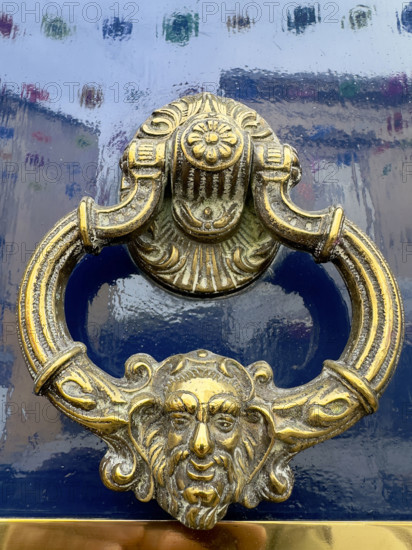 Brass door knocker on blue lacquer door