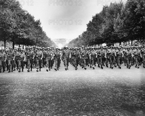 American troops of 28th Infantry Division march down Champs Elysees, in "Victory" parade, Paris, France, U.S. Army Signal Corps, August 29, 1944