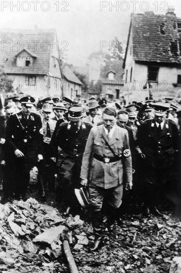 Adolf Hitler, accompanied by other German officials, grimly inspecting bomb damage in German city, German film captured by the U.S. Army Signal Corps, 1944