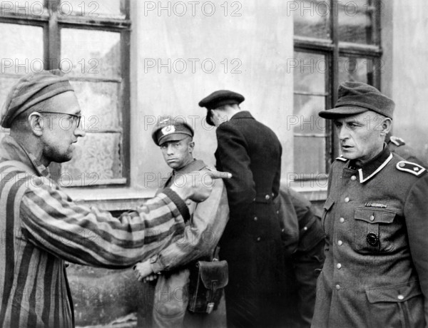 Russian slave laborer among prisoners liberated by U.S, 3rd Armored Division pointing out former Nazi guard who brutally beat prisoners, Germany, U.S. Army Signal Corps, May 1945