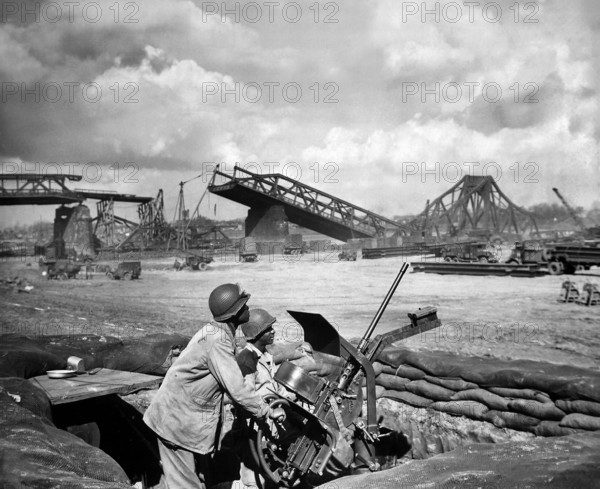 U.S. Privates George Cofield and Howard J. Davis guarding newly-constructed bridge site over Rhine River built by U.S. Ninth Army Engineers, Germany, U.S. Army Signal Corps, March 30, 1945