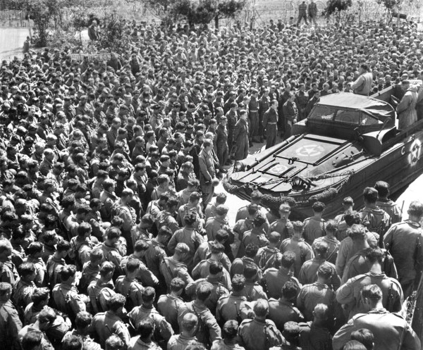 U.S. Lieutenant Colonel Woran, Chaplain of the 10th Mountain Division, leading group of men in prayer the day following the unconditional surrender of all German troops, Torboli (Nago-Torbole), Italy, U.S. Army Signal Corps, May 3, 1945