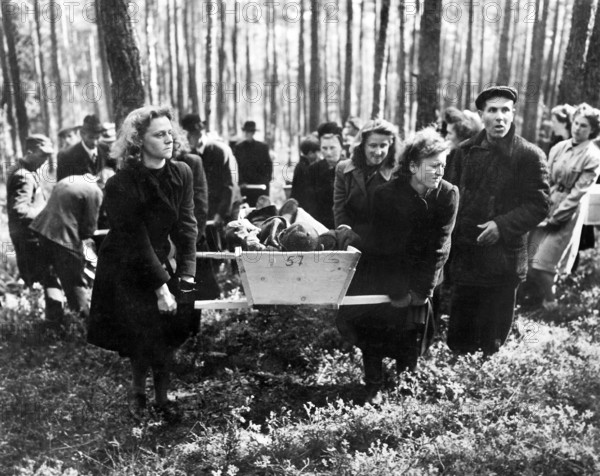 Civilians bearing victims of SS killings to burial ground, after bodies were exhumed from mass grave where their murderers had dumped them, Neunburg, Bavaria, Germany, U.S. Army Signal Corps, April 29, 1945
