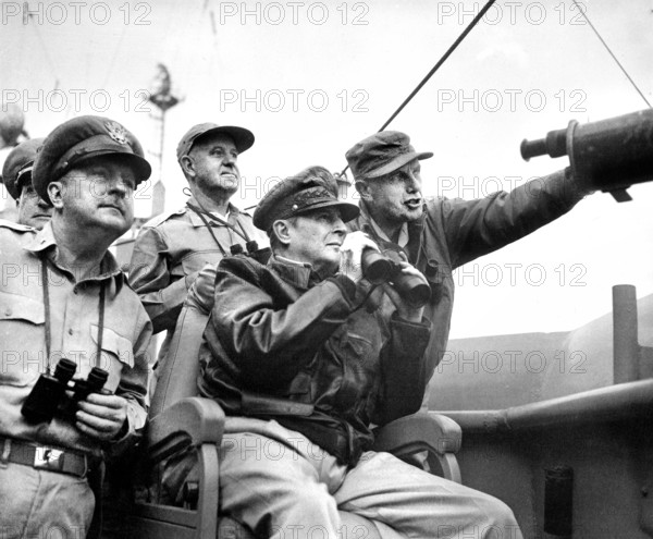 U.S. Brigadier General Courtney Whitney; U.S. General Douglas MacArthur, Commander in Chief of U.N. Forces; and U.S. Major General Edward Almond, observing the shelling of Inchon from U.S.S. Mt. McKinley, U.S. Army Signal Corps, September 15, 1950