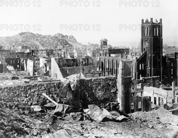 Damaged area from earthquake north of California street in vicinity of Grant Avenue showing Telegraph Hill in the distance. The church standing on right is Saint Mary's Church, entrance to Chinatown. Area adjacent to Saint Mary's Church, showing crumpled tower is Hall of Justice on Kearny and Clay Streets, San Francisco, California, USA, U.S. Army Signal Corps, April 1906