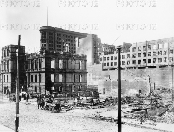 Damaged buildings east side of Fifth Street between Market Street and Mission Street after earthquake, Lincoln Grammar School (extreme left), Flood Building (center with flagstaff), Emporium Department Store (ruined on extreme right at Market Street), San Francisco, California, USA, U.S. Army Signal Corps, April 1906