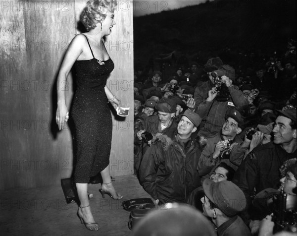 Marilyn Monroe, American motion picture actress, appearing with USO Camp Show, "Anything Goes," greeting soldiers after performance at 3rd U.S. Infantry Division area, South Korea, U.S. Army Signal Corps, February 17, 1954