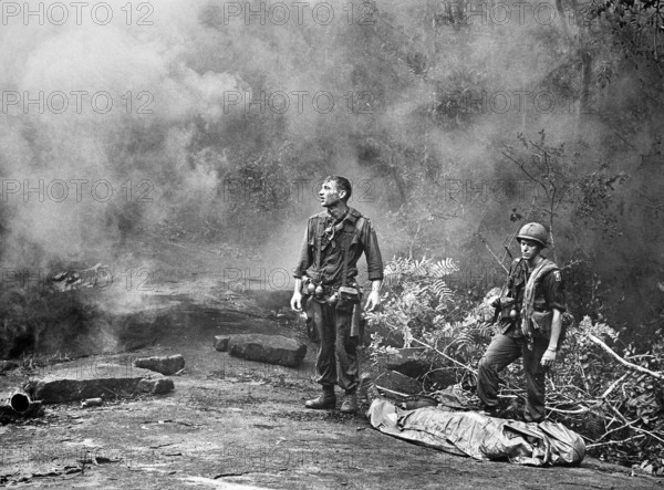 SP4 R. Richter, 4th Battalion, 503rd Infan1try, 173rd Airborne Brigade with Sergeant Daniel E. Spencer as they await helicopter to transport fallen comrade, Long Khanh Province, Republic of Vietnam, U.S. Army Signal Corps, 1966