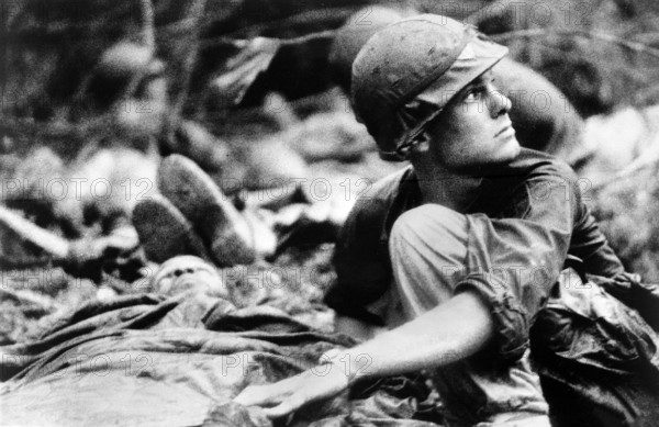 Operation "Billings" Medic from 1st Battalion, 16th Infantry, 1st Infantry Division, searching sky for Medevac helicopter to evacuate wounded soldier, following air assault into LZ Rufe, Phu?c Vinh, South Vietnam, U.S. Army Signal Corps, June 15, 1967