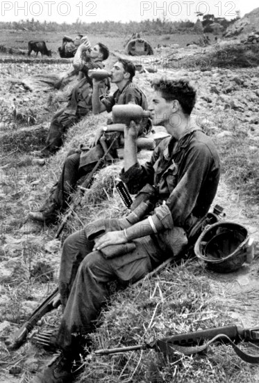Members of U.S.25th Infantry Division drinking from their canteens during break in patrol operations, Duc Pho, Vietnam, U.S. Army Signal Corps, August 31, 1967