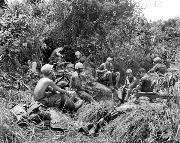 Members of Companies B and D, 1st Battalion, 501st Infantry, Regiment, 101st Airborne Division, taking break from jungle fighting east of Tam Ky, Vietnam, U.S. Army Signal Corps, June 2, 1969