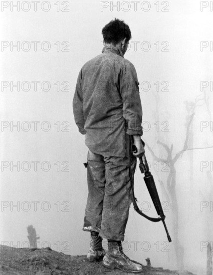 Member of the U.S. 5th Infantry Division (Mechanized) looking out over fog-shrouded A Shau Valley, Vietnam, U.S. Army Signal Corps, 1969