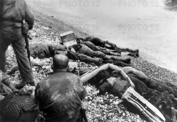 American assault troops of the 3rd Battalion, 16th Regiment, 1st US Infantry Division, who failed in their attempt to storm across a narrow strip of beach, Omaha Beach, Colleville-sur-Mer, Normandy, France, U.S. Army Signal Corps, June 6, 1944