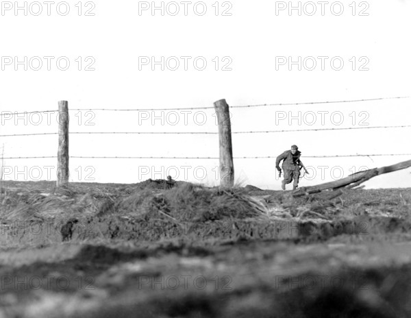 U.S. infantryman of 82nd Airborne Division, going on one-man sortie, covered by buddy in background, Belgium, U.S. Army Signal Corps, Dec. 24, 1944