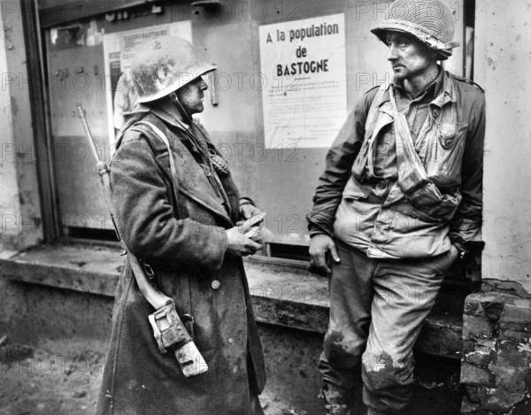 Two infantrymen of the 110th Regiment, 28th Division, U.S. 1st Army, (L-R) Private Adam H. Davis, T/S Milford A. Sillars, following German breakthrough in the area, Bastogne, Belgium, U.S. Army Signal Corps, December 19, 1944