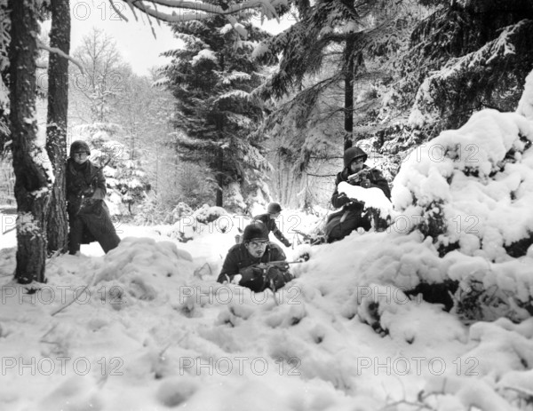 American infantrymen of the 29th Regiment., 75th Infantry Division fighting in fresh snowfall near Amonines, Belgium, U.S. Army Signal Corps, January 4, 1945
