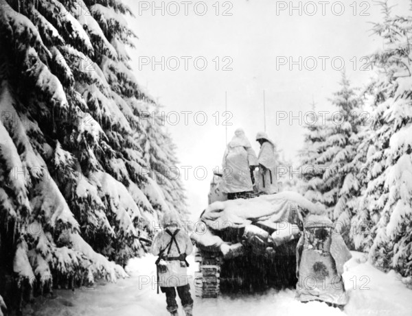 U.S. tank and Infantrymen of the 82nd Airborne Division pushing through snow, near Herresbach, Belgium, U.S. Army Signal Corps, January 1945