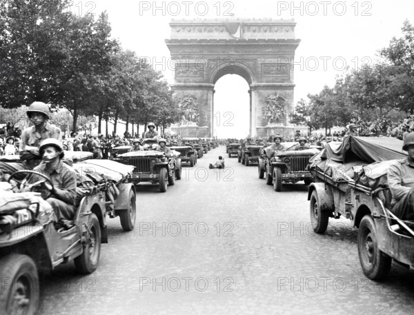 Military jeeps of American 28th Infantry Division moving down Champs Elysees, passing through Arc de Triomphe, Paris, France, U.S. Army Signal Corps, August 29, 1944