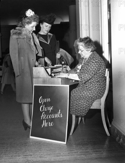 Two women opening up charge accounts, Saks Fifth Avenue, Detroit, Michigan, USA, Arthur S. Siegel, U.S. Office of War Information, October 1942