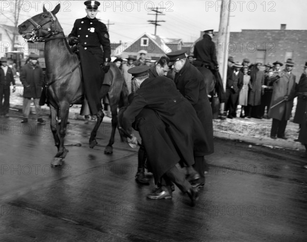 Police arresting rioter at Sojourner Truth Homes, a U.S. Federal Housing Project, caused by white neighbors' attempting to prevent black tenants from moving in. Detroit, Michigan, USA, Arthur S. Siegel, U.S. Office of War Information, February 1942