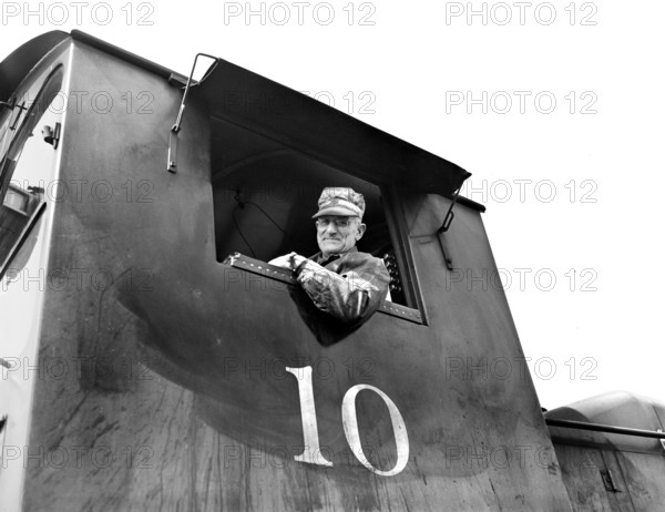 Train engineer in one cab of locomotive train, Detroit, Michigan, USA, Arthur S. Siegel, U.S. Office of War Information, April 1943