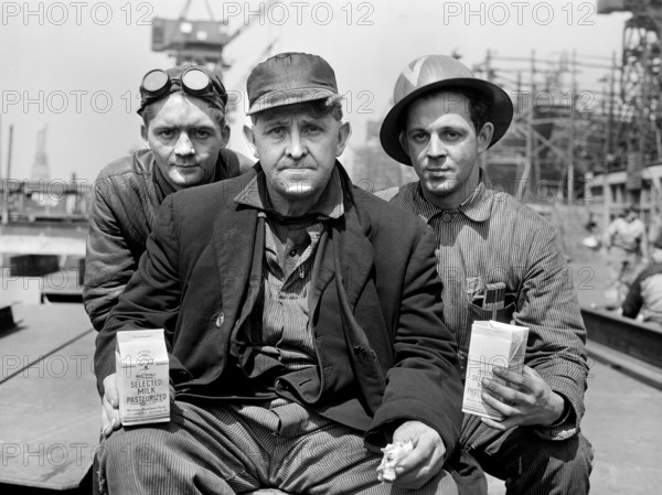 Three factory workers on lunch break, Bethlehem-Fairfield shipyards, Baltimore, Maryland, USA, Arthur S. Siegel, U.S. Office of War Information, May 1943