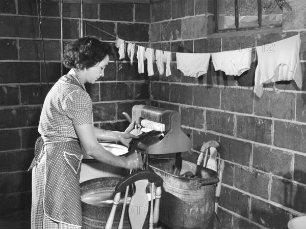Woman wringing out washed clothes, Point Pleasant, West Virginia, USA, Arthur S. Siegel, U.S. Office of War Information, May 1943