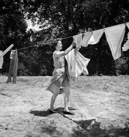 Woman removing laundry from clothes line, Point Pleasant, West Virginia, USA, Arthur S. Siegel, U.S. Office of War Information, May 1943