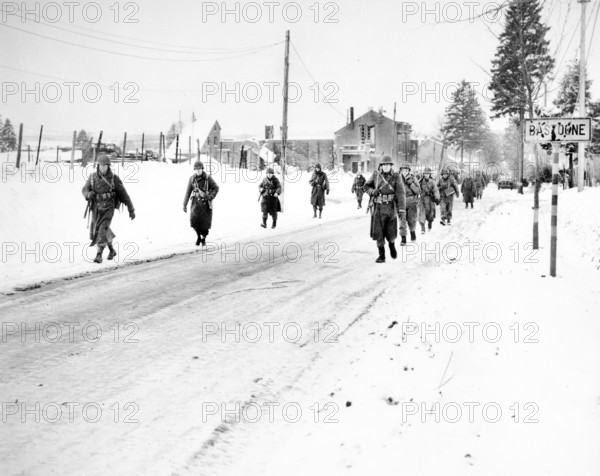 Members of U.S. 101st Airborne Division on the move out of Bastogne, Belgium, to drive Germans who have besieged them for ten days, out of a neighboring town, U.S. Army Signal Corps, December 29, 1944
