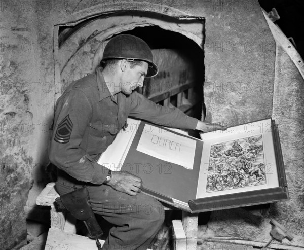 U.S. Master Sergeant Harold Maus with Albrecht Durer engraving, found among other art treasures by 3rd U.S. Army in salt mine vaults, Merkers, Germany, U.S. Army Signal Corps, May 13, 1945