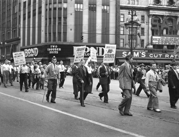 Members of the United Automobile Workers (UAW) of the Congress of Industrial Organizations (CIO) carrying various signs in the Labor Day parade, Detroit, Michigan, USA, Arthur S. Siegel, U.S. Office of War Information, September 1942