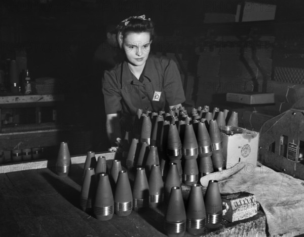 Female factory worker inspecting 60mm shells, Budd Wheel Plant, Detroit, Michigan, USA, Arthur S. Siegel, U.S. Office of War Information, January 1943