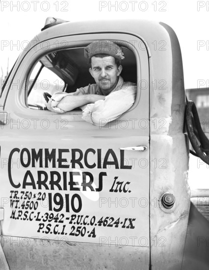 Truck driver, Commercial Carriers, Inc., transports U.S. military vehicles from manufacturing plant, Detroit, Michigan, USA, Arthur S. Siegel, U.S. Office of War Information, April 1943
