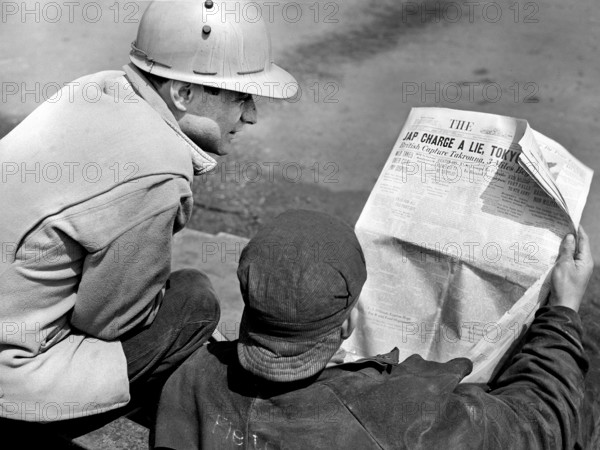 Two factory workers reading the Baltimore Sun newspaper during lunch time, Bethlehem-Fairfield shipyards, Baltimore, Maryland, USA, Arthur S. Siegel, U.S. Office of War Information, May 1943