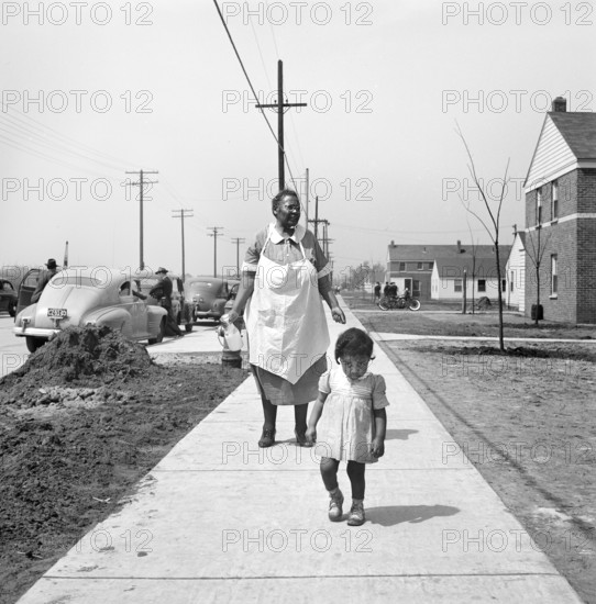 Mother and child waking on sidewalk, Sojourner Truth Homes, a U.S. Federal Housing Project, Detroit, Michigan, USA, Arthur S. Siegel, U.S. Office of War Information, February 1942