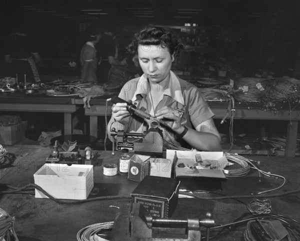 Female worker soldering contact point on end of wire, De Soto bomber plant, Detroit, Michigan, USA, Arthur S. Siegel, U.S. Office of War Information, October 1942